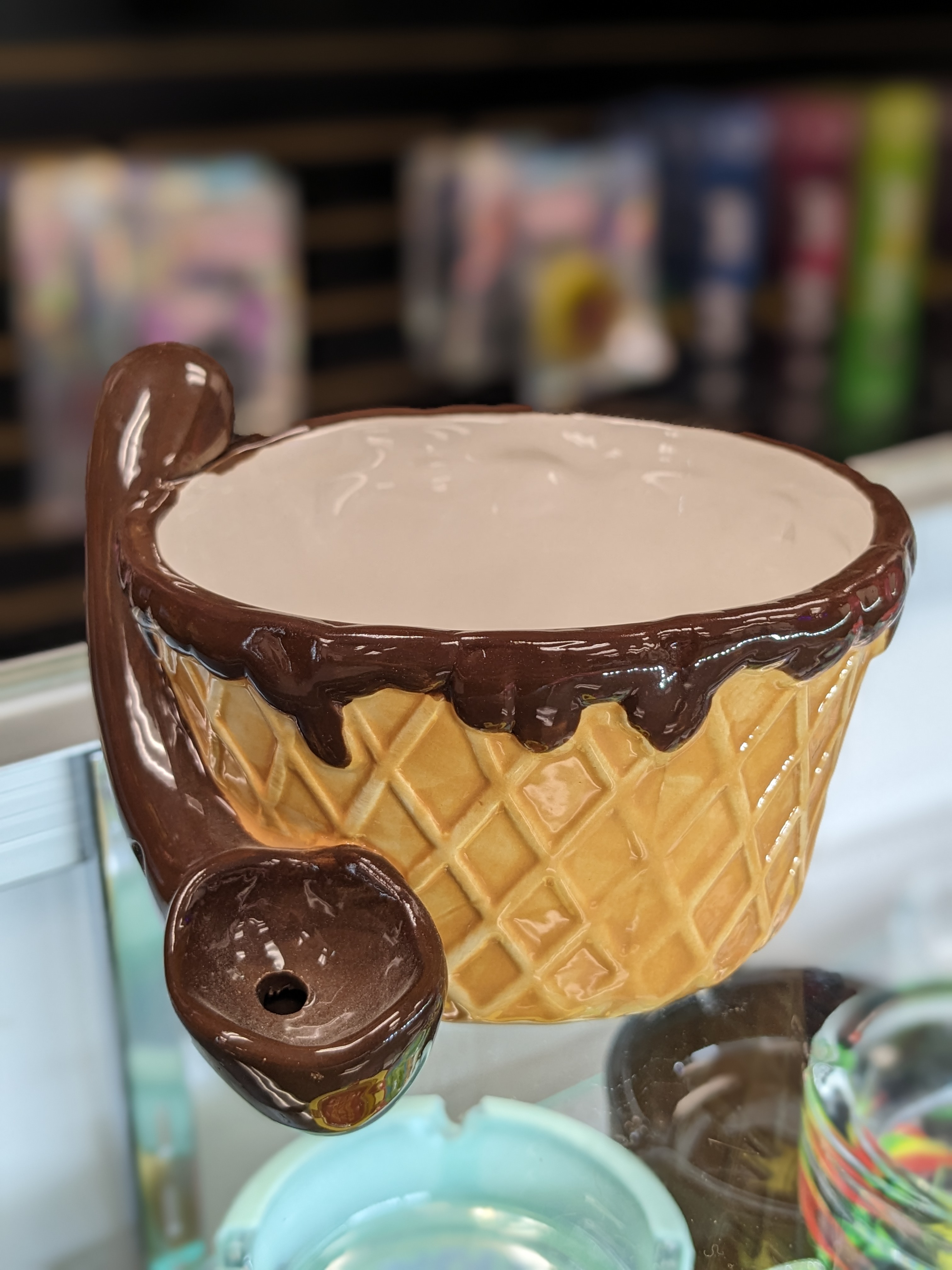 A chocolate ice cream sundae sitting on top of a refrigerator