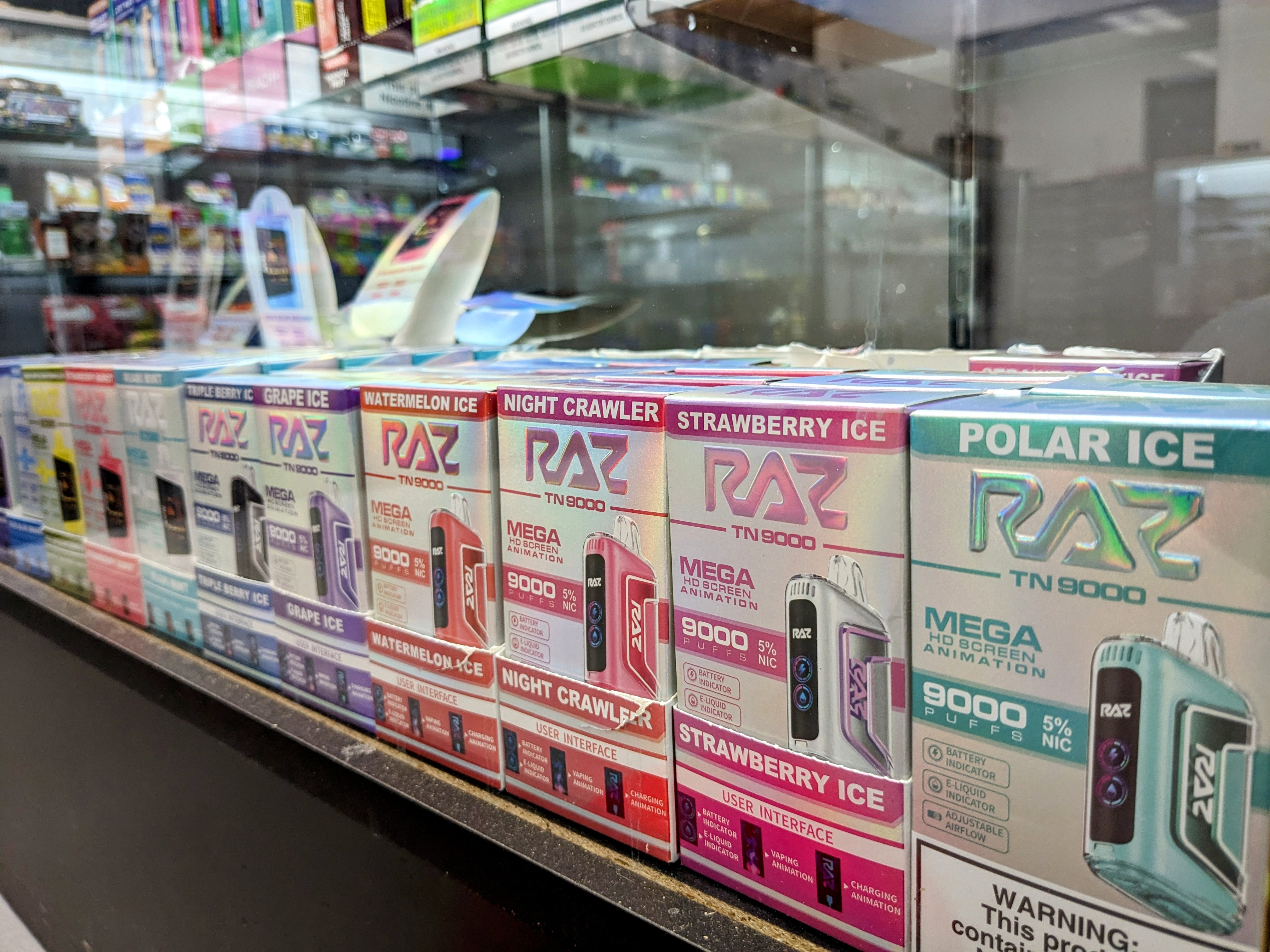 A display case in a store filled with different types of razors